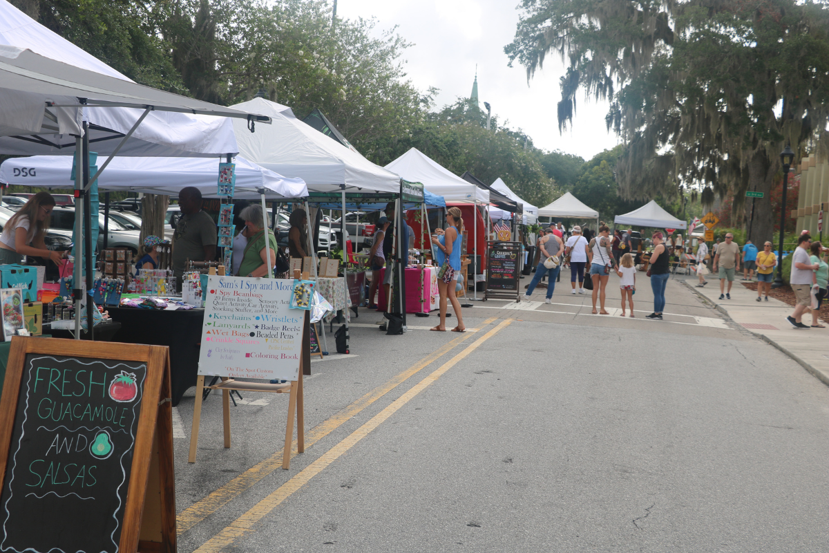 An array of pop-up tents and canopies line SE 3rd Street in Downtown Ocala selling an array of homemade goods.
