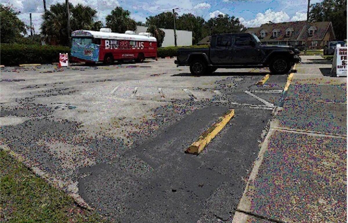 Bradley Blessing State Farm parking lot with vehicle, B.R.T. bus, and worn pavement.