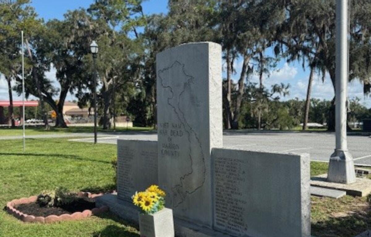 Vietnam Veterans Memorial in front of Belleview City Hall with fresh flowers and cleaned stone panels.