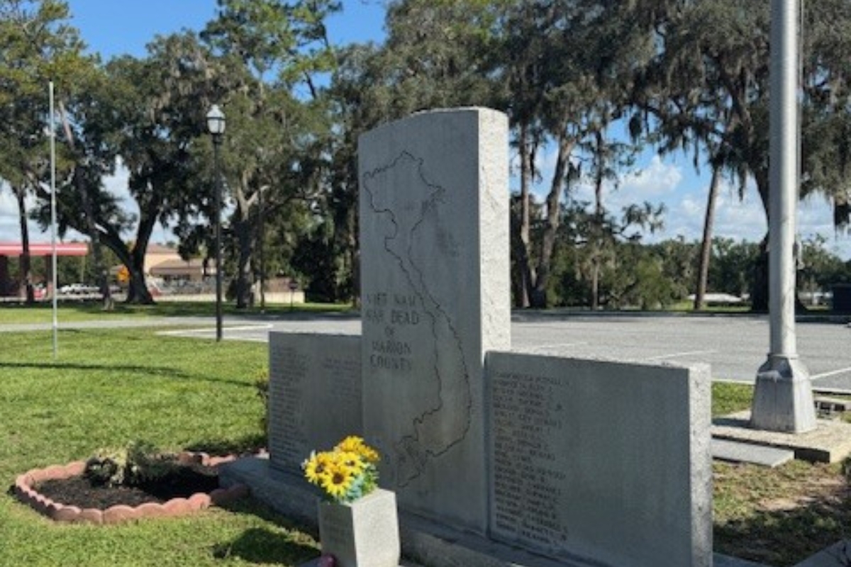 Vietnam Veterans Memorial in front of Belleview City Hall with fresh flowers and cleaned stone panels.