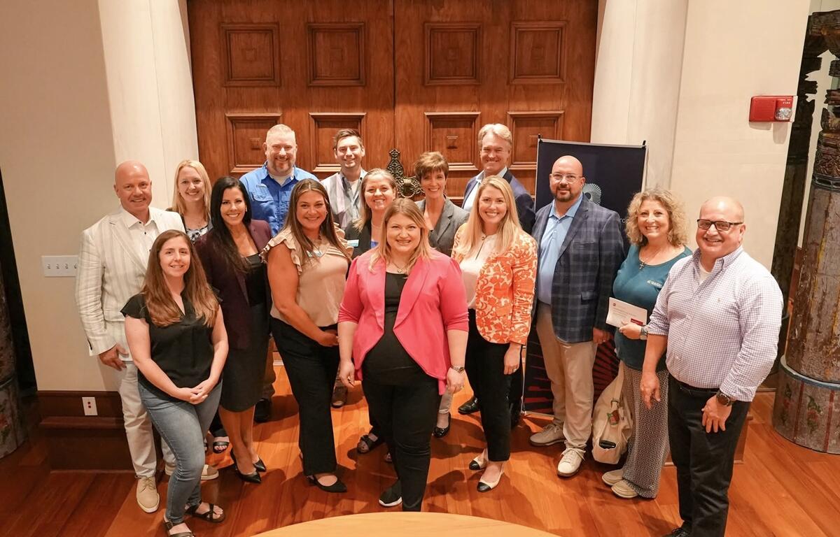 Kat Cammack stands with business leaders and chamber members during a tax policy roundtable in Ocala.