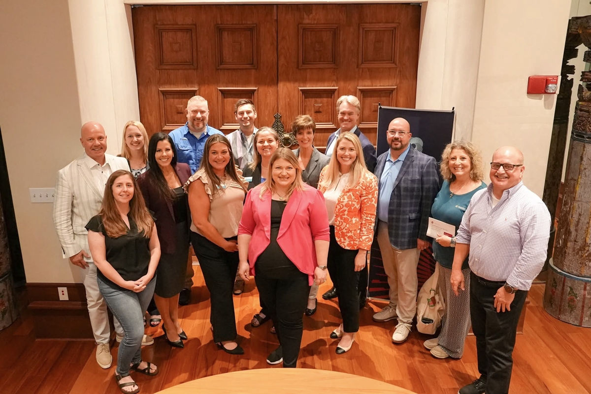 Kat Cammack stands with business leaders and chamber members during a tax policy roundtable in Ocala.