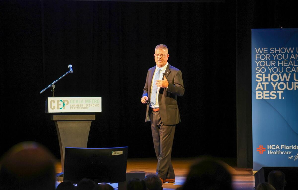 State Attorney Bill Gladson delivers a presentation onstage at the Ocala Metro CEP breakfast event.