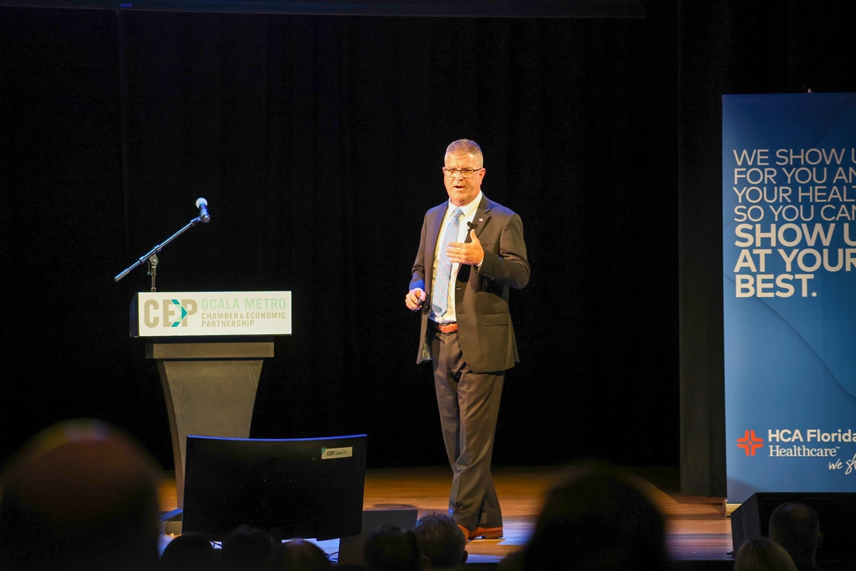 State Attorney Bill Gladson delivers a presentation onstage at the Ocala Metro CEP breakfast event.