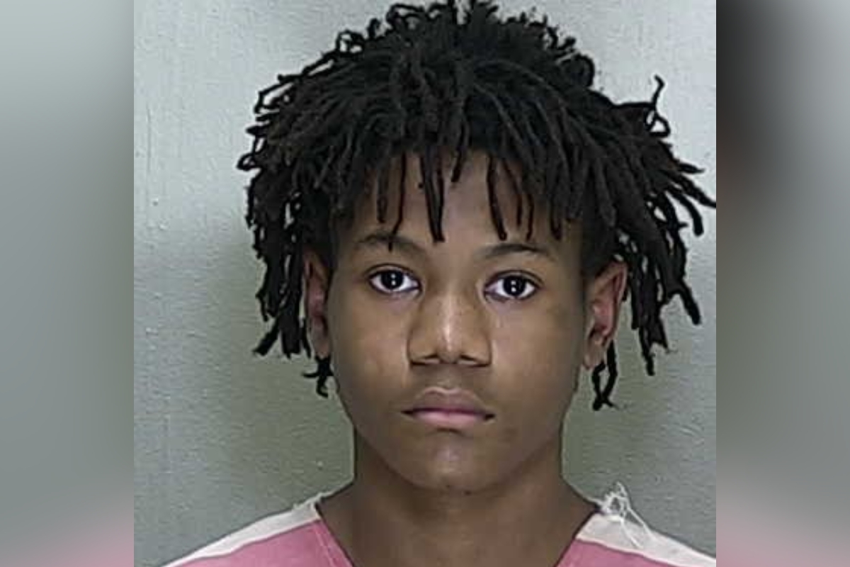 Mugshot of Christopher Atkins, 15, wearing a pink-striped jail uniform.