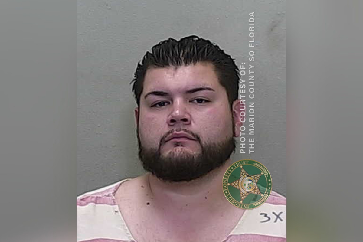 Mugshot of Christopher Rivera, a 30-year-old man with dark hair and a beard, wearing a pink and white striped shirt, taken by the Marion County Sheriff's Office.