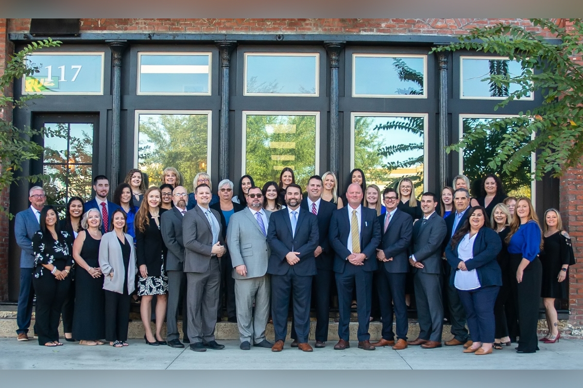 Group photo of Douglas Law Firm attorneys and staff standing in front of the Ocala office building.