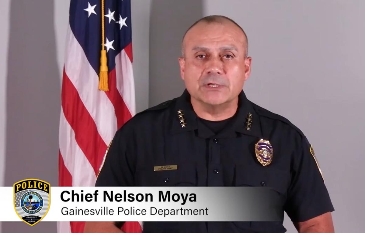 Gainesville Police Chief Nelson Moya speaks in front of an American flag during a public video appeal.