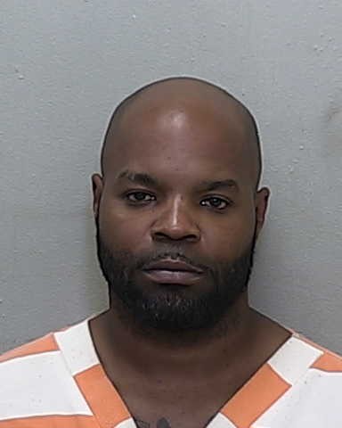 Booking photo of Howard Reece in an orange and white striped jail uniform.