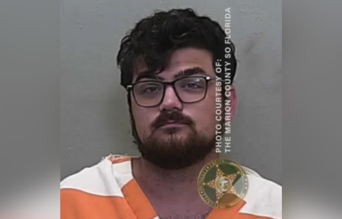 Mugshot of Hunter Rodgers wearing an orange and white jail uniform.