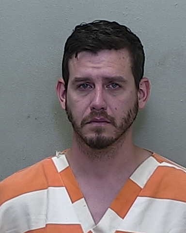 Mugshot of Jack Grimsley in orange and white jail uniform