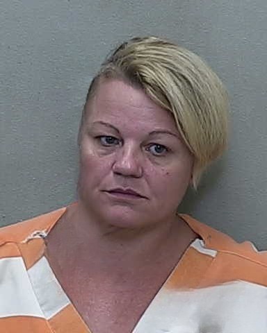 Mugshot of Lauralie Daniels in orange and white jail uniform