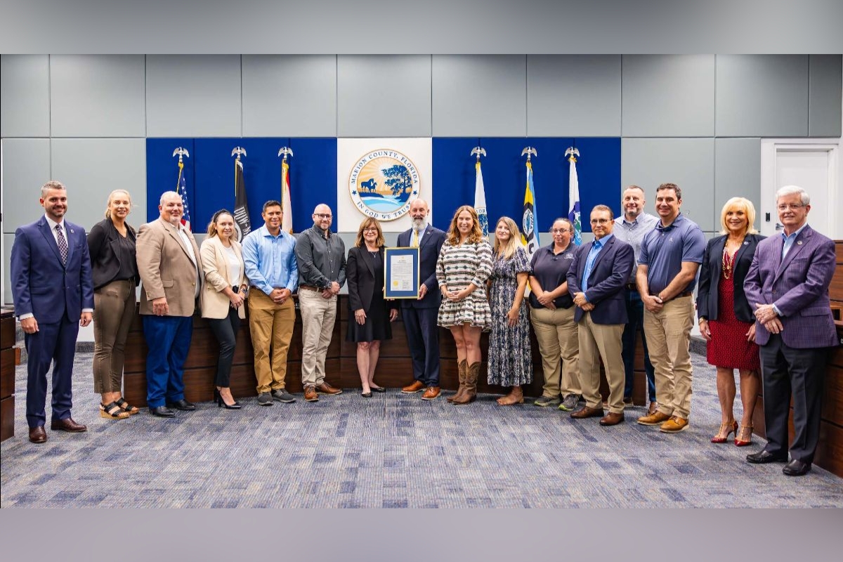 Marion County officials and staff pose together with a proclamation at a board meeting.