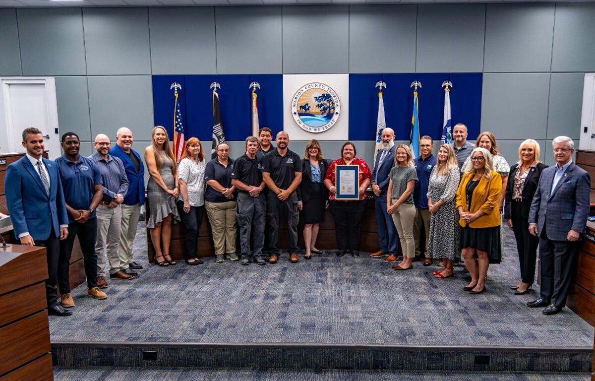 Group photo of Marion County commissioners and parks staff holding a proclamation in the board chambers.
