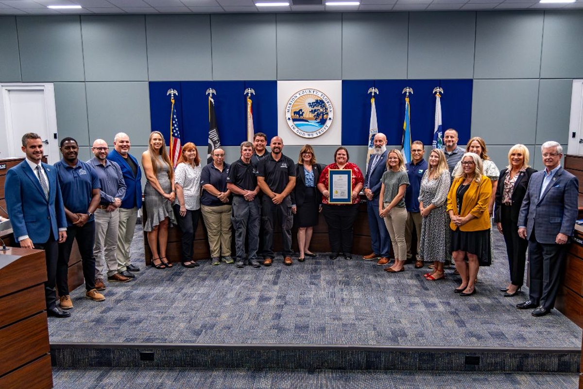 Group photo of Marion County commissioners and parks staff holding a proclamation in the board chambers.