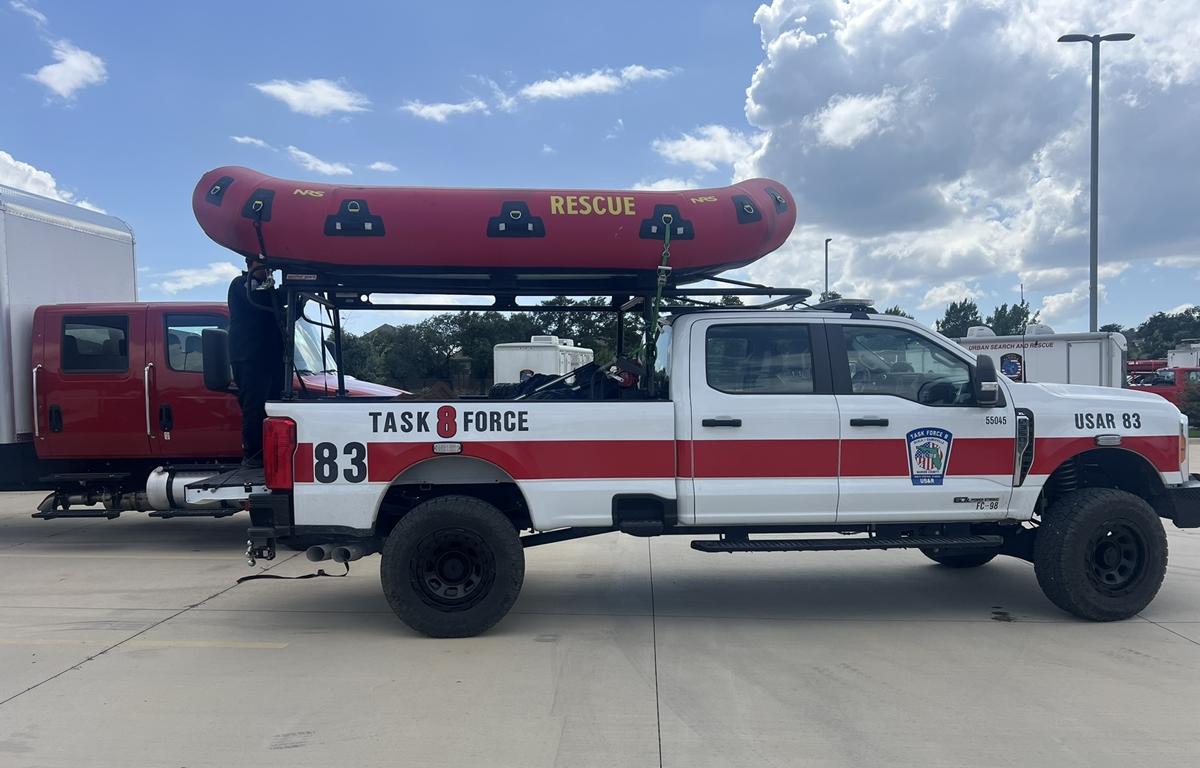 Task Force 8 truck with mounted red rescue boat parked at deployment site