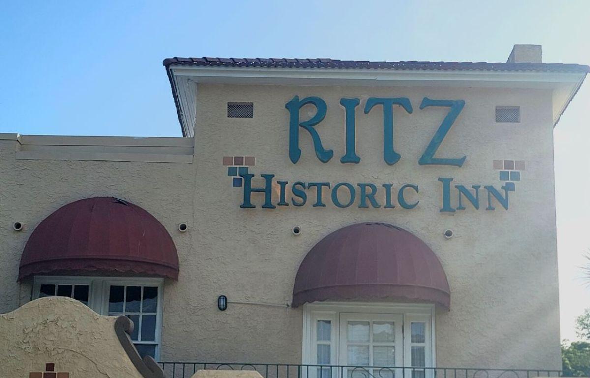 Exterior of The Ritz Historic Inn in Ocala with red awnings and teal lettering