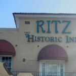 Exterior of The Ritz Historic Inn in Ocala with red awnings and teal lettering
