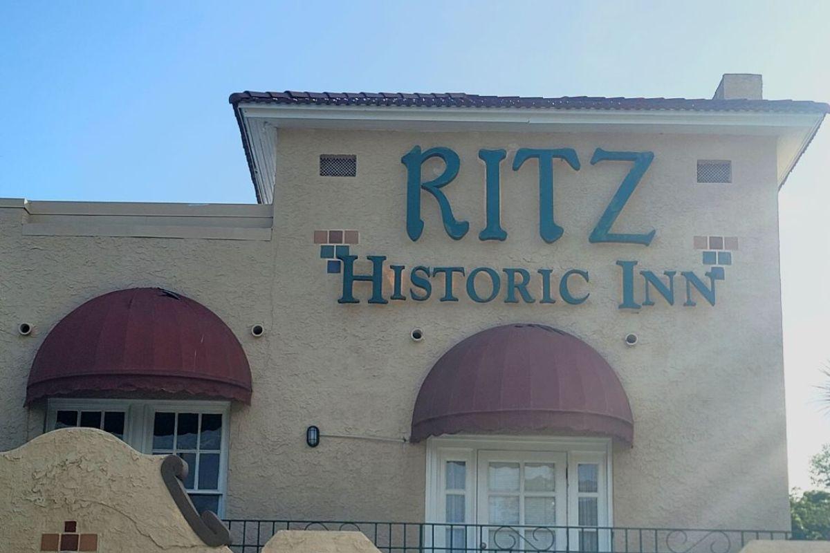 Exterior of The Ritz Historic Inn in Ocala with red awnings and teal lettering