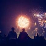 Crowd watching fireworks light up the night sky at Tavares July 4th event.