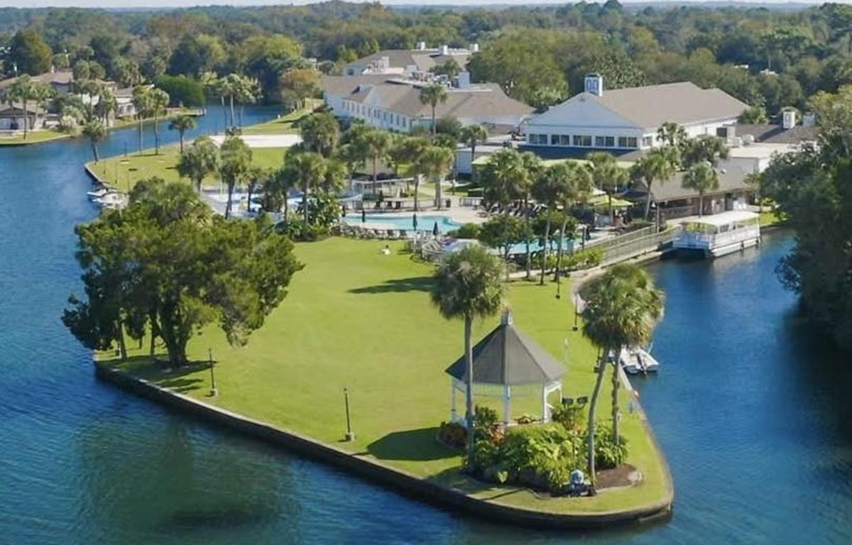 Aerial view of Plantation Resort in Crystal River, showing hotel buildings, swimming pool, marina, and surrounding waterways.