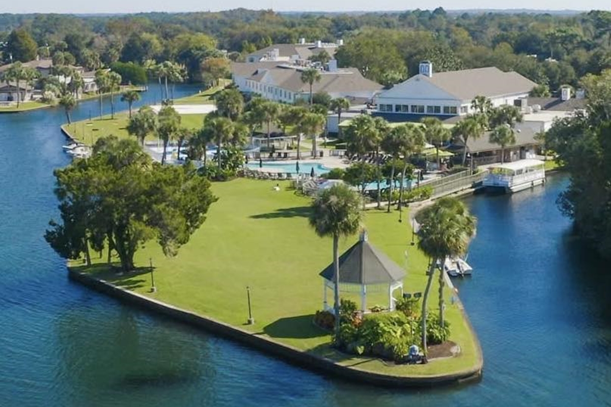 Aerial view of Plantation Resort in Crystal River, showing hotel buildings, swimming pool, marina, and surrounding waterways.