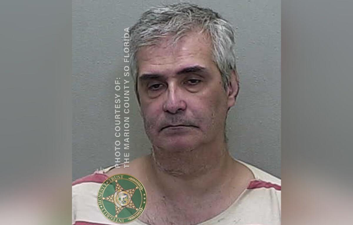 Mugshot of Roberto Maurizio Stracuzzi, a 56-year-old man with gray hair, wearing a striped jail uniform, arrested by Marion County Sheriff's Office.