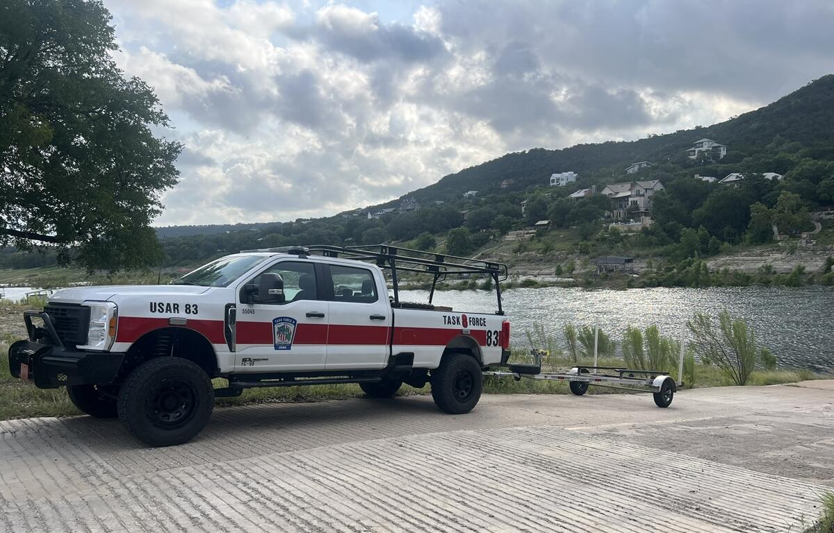Florida Task Force 8 truck with trailer parked by a lake in Texas during flood response mission.