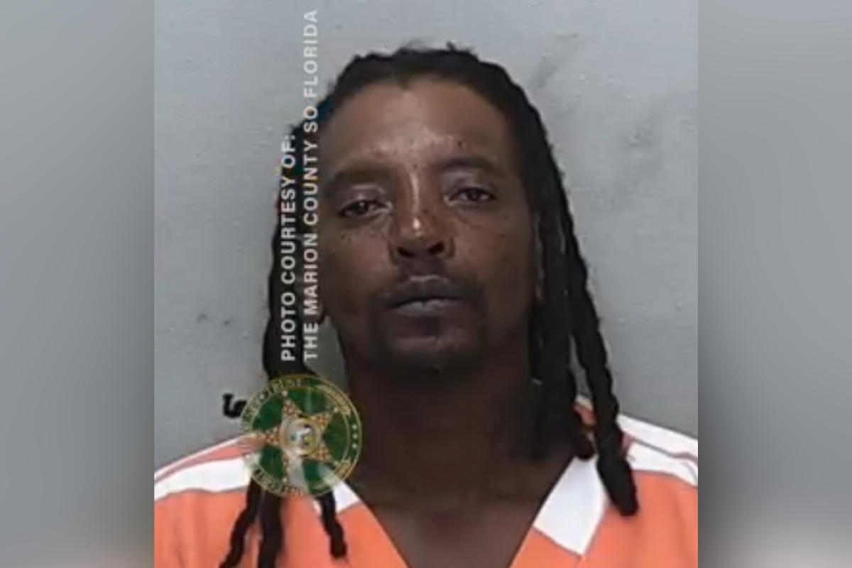 Booking photo of Clifford Shells wearing an orange and white jail uniform.