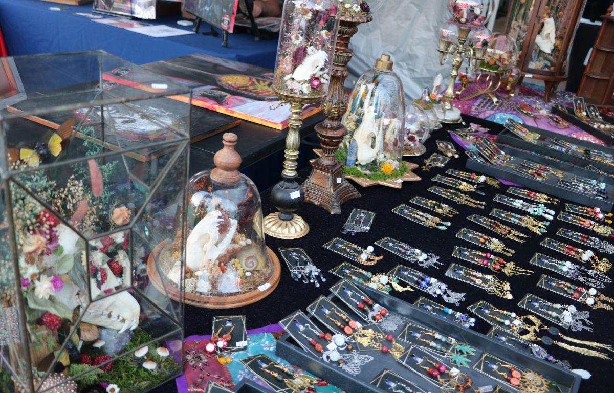 A display combining beaded jewelry and decorative skulls in a lively booth setup.
