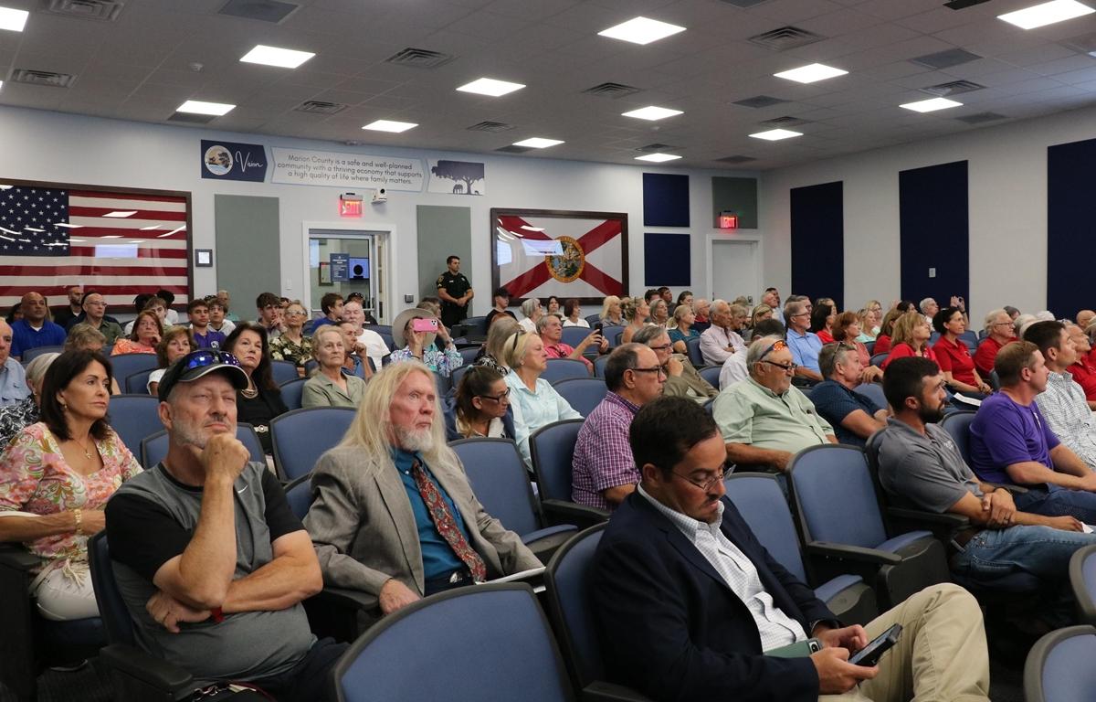 Large audience seated in Marion County Commission chambers during public hearing.
