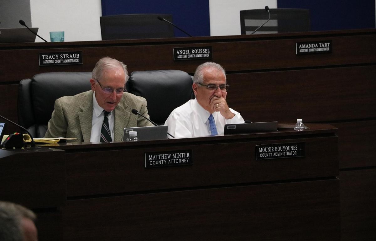 Matthew Minter and Mounir Bouyounes seated at the commission dais during a Marion County hearing.