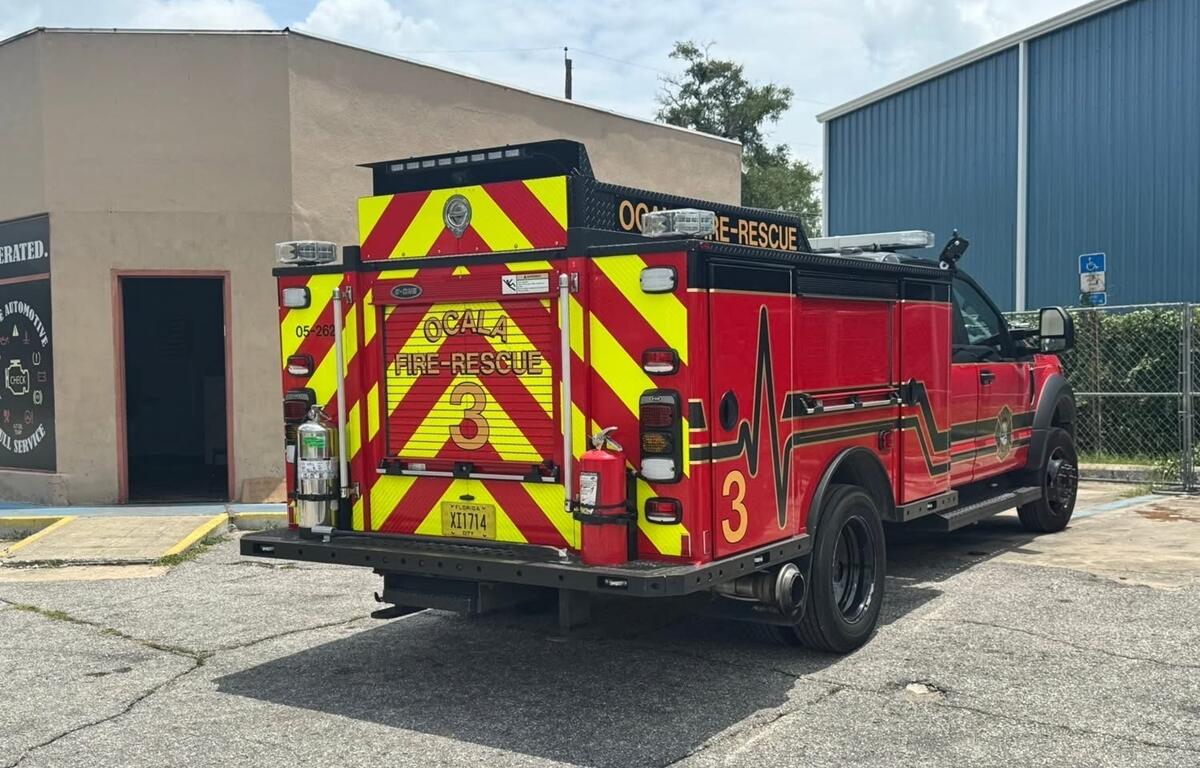 Ocala Fire Rescue Truck 3 parked outside tan commercial building during firefighter training