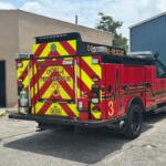 Ocala Fire Rescue Truck 3 parked outside tan commercial building during firefighter training