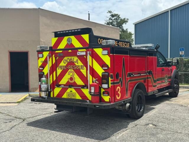 Ocala Fire Rescue Truck 3 parked outside tan commercial building during firefighter training