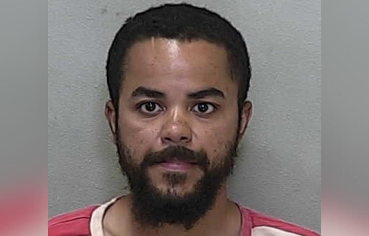 Mugshot of Za’Mond Shanard Smith, a 25-year-old man with a beard, wearing a red and white jail uniform, arrested on July 1, 2025.