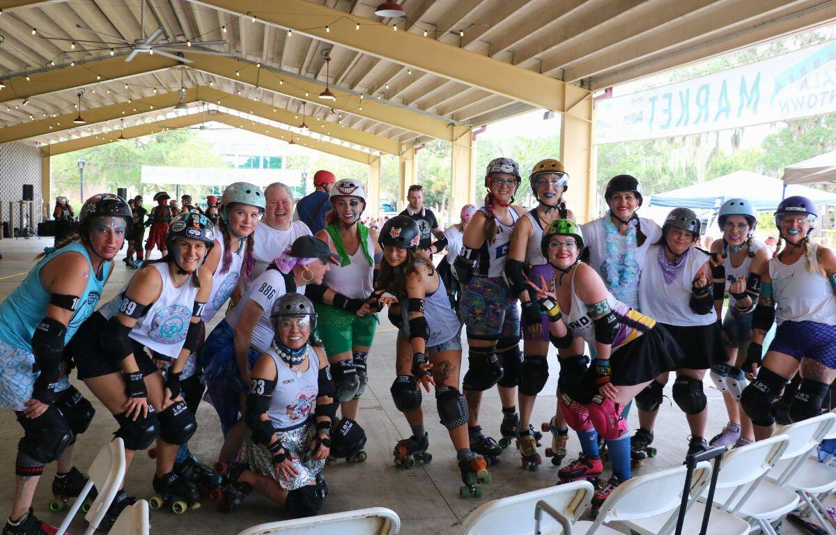 Wide shot of the Mermaids with their bench coach before the game.