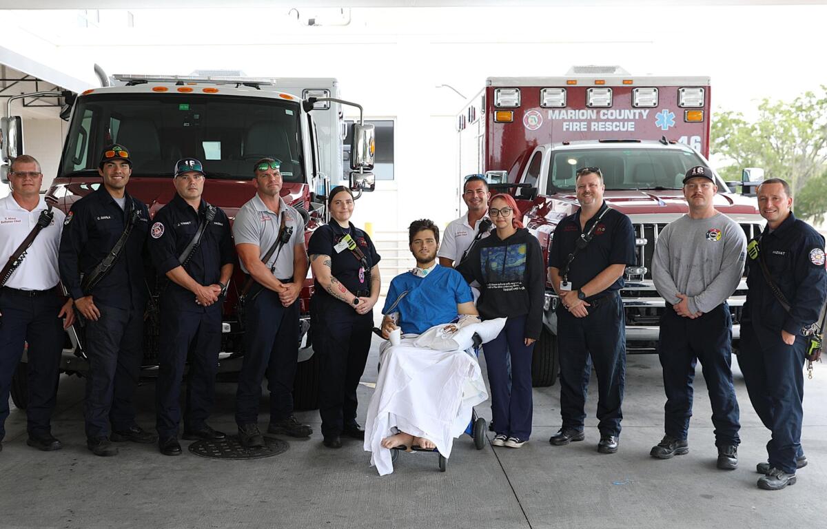 Max Gagnon stands with the Marion County Fire Rescue team who pulled him from the wreckage of his truck after a life-threatening crash.