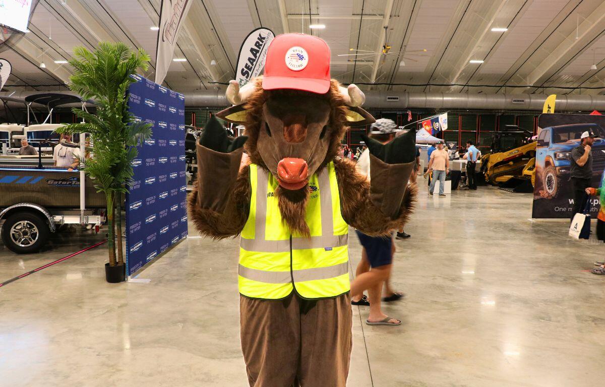 Person in a safety vest and helmet costume posing for photos with children.