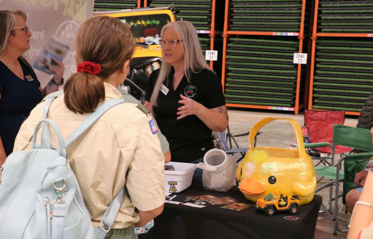 Families and visitors interacting with vendors and activities at the expo.