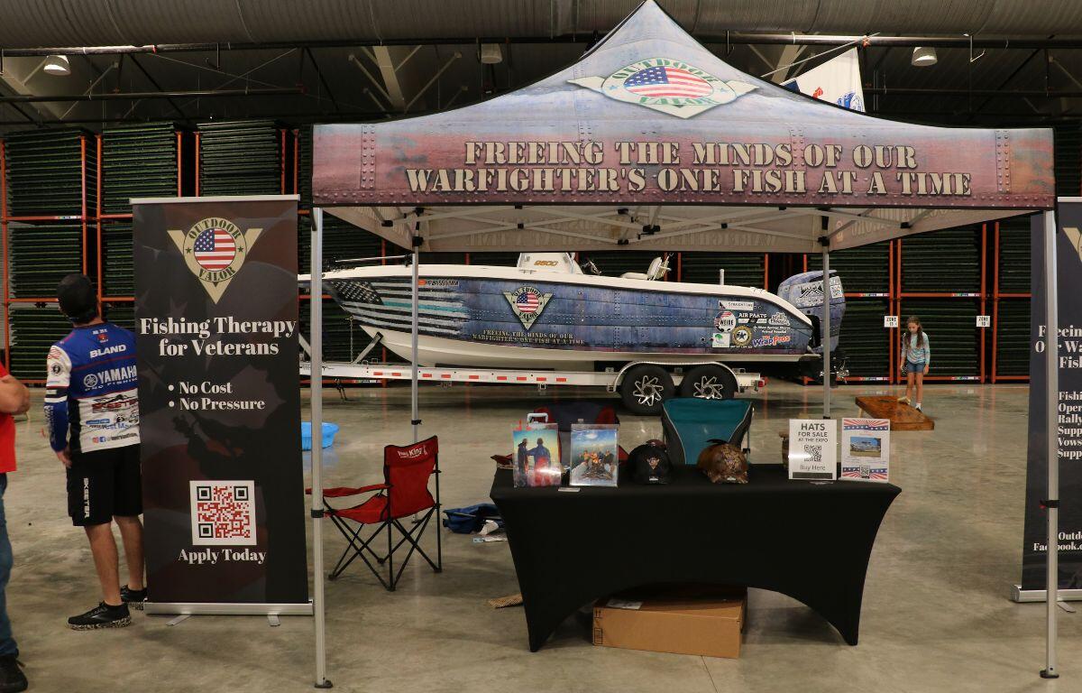 Outdoor vendor tent promoting Fishing for Veterans with informational