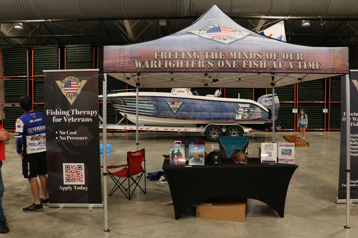 Outdoor vendor tent promoting Fishing for Veterans with informational