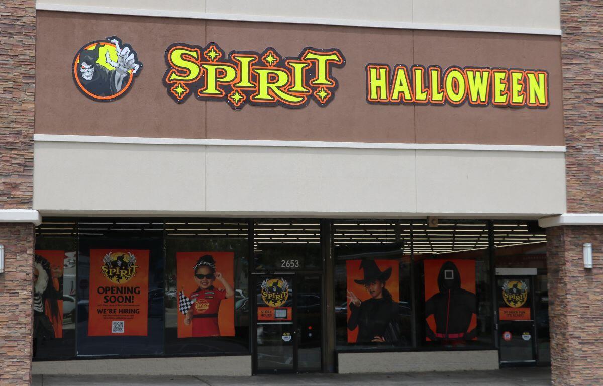 Exterior view of a Spirit Halloween store with a bright sign above the entrance.