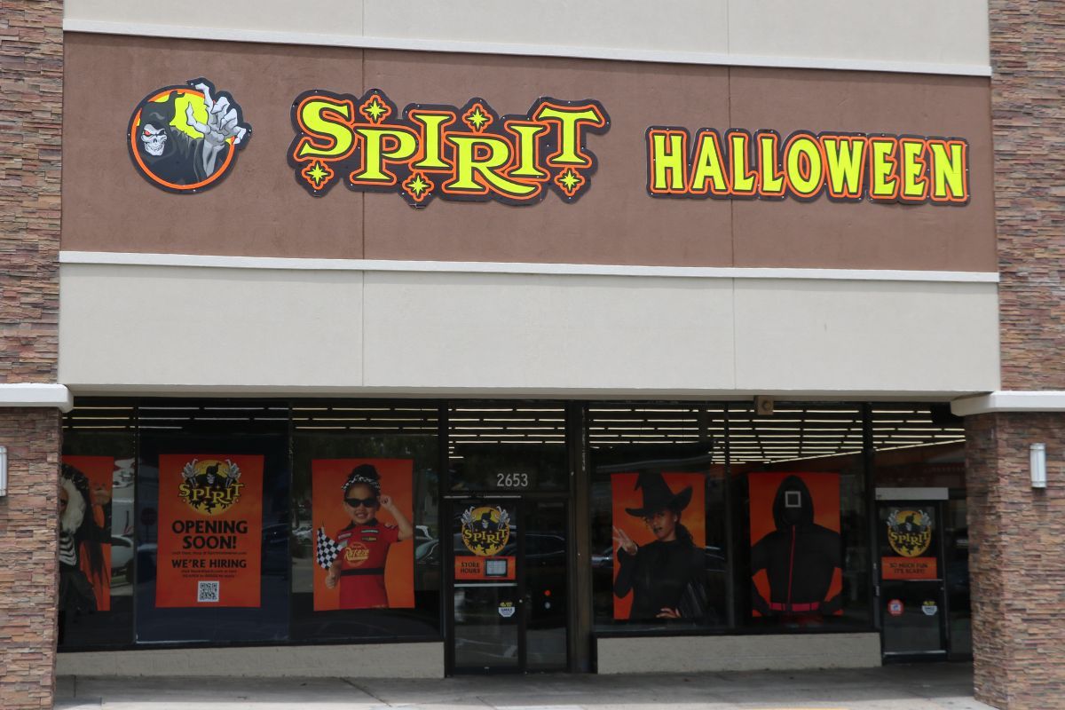 Exterior view of a Spirit Halloween store with a bright sign above the entrance.