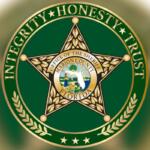 Circle, and inside the circle lettering, and then a badge with lettering and an insignia, with a green background inside the circle.