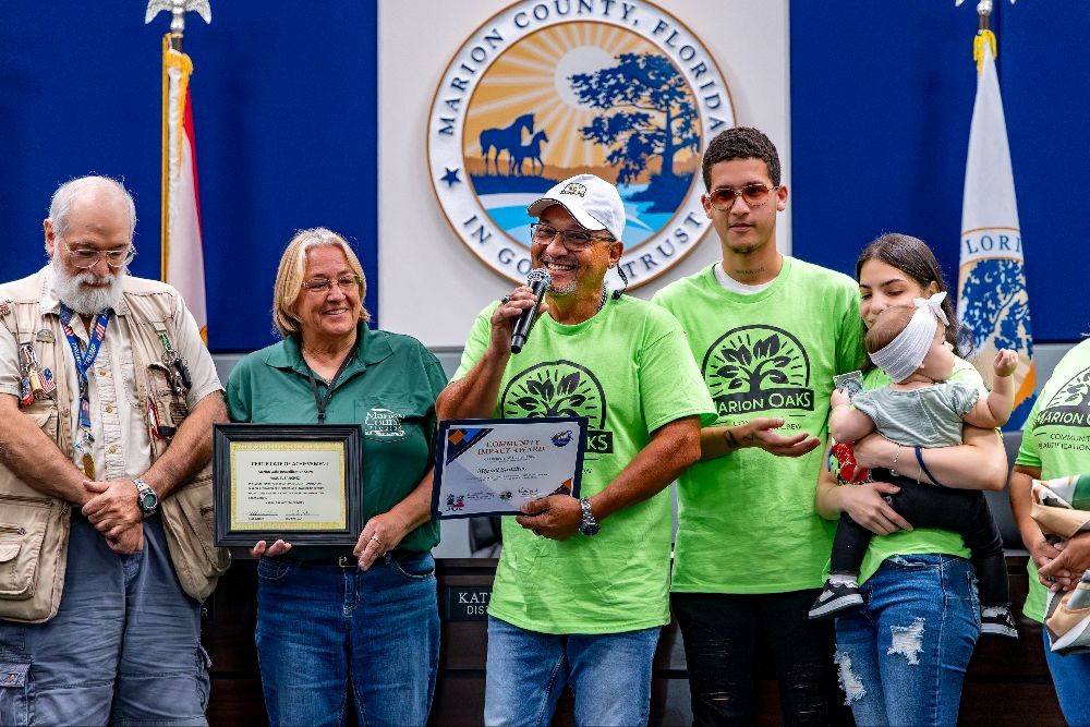 Miguel Sanchez smiles while talking about his group, the Marion Oaks Community Beautification Crew, at the Aug. 19 Marion County Commission meeting.