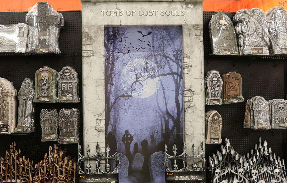 Decorative Halloween photo backdrop with themed props inside Spirit Halloween.