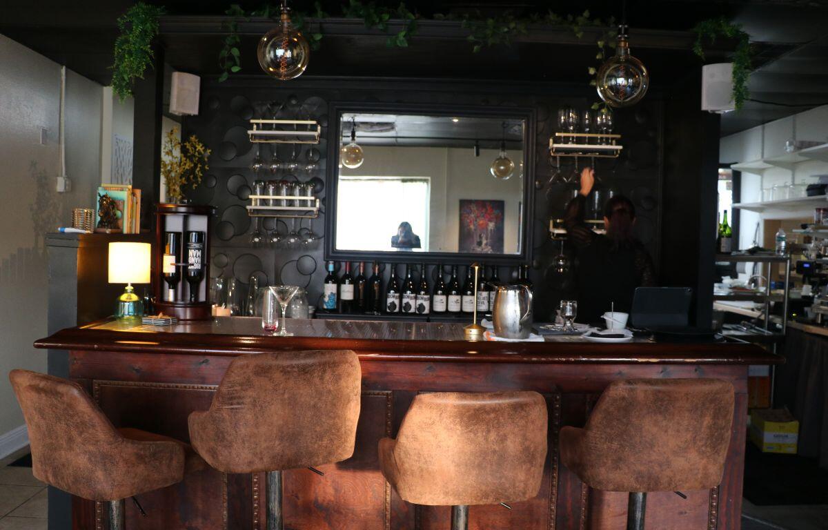 Elegant bar with cushioned stools and warm lighting.