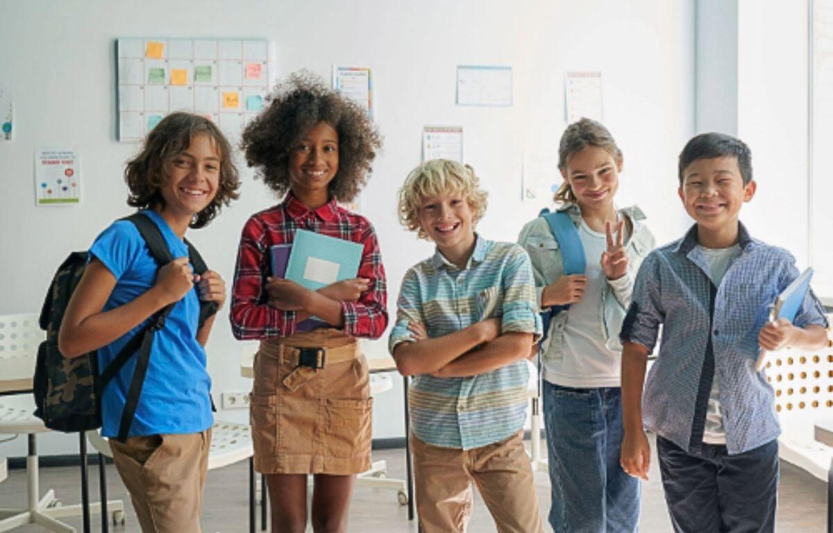 A diverse group of smiling school-aged children stand in front of a colorful “Back to School Immunizations” banner, promoting free vaccines offered by the Florida Department of Health in Marion County.