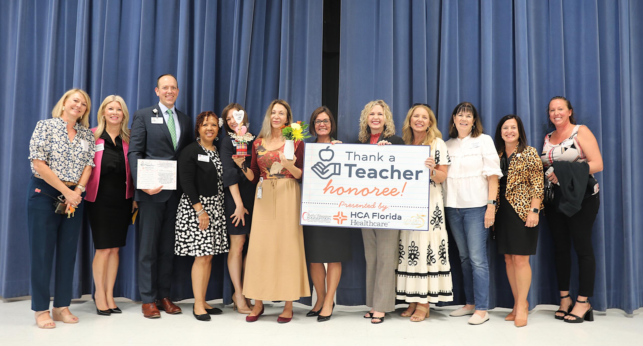 Pictured from left to right: Angela Ponder, principal, Hammett Bowen Jr. Elementary School; Meghan Magamoll, executive director, PEFMC; Alan Keesee, chief executive officer, HCA Florida Ocala Hospital; Stephanie Hill-Palmer, PEFMC board member; Erin Buss, PEFMC board member; Rebecca Koloszy, Thank a Teacher recipient; Danielle Brewer, interim superintendent, MCPS; Allison Campbell, MCPS school board member; Lori Conrad, chairwoman, MCPS school board; Julie Shealy PEFMC board member; Melissa Conner; Renae Robinson, PEFMC board member.